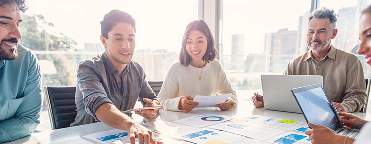 Photo of business colleagues meeting and studying papers.