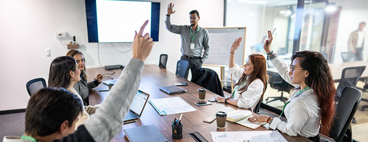 Photo of business people casting vote around a meeting table.