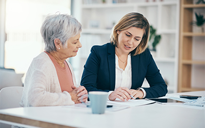 Photo of wealth advisor helping client.