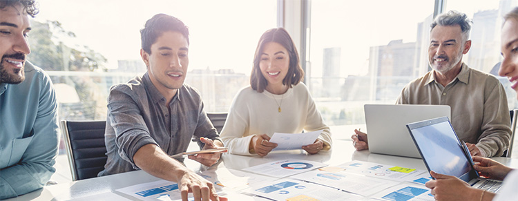 Photo of business colleagues meeting and studying papers.