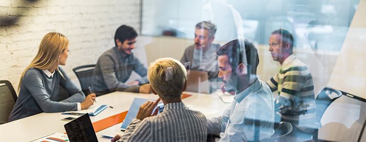 Photo of business people sitting in a meeting.