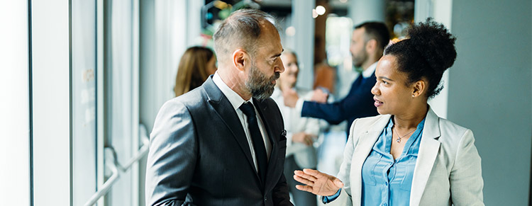 Photo of two colleagues in conversation.